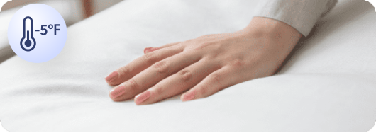 Hand touching a cooled mattress